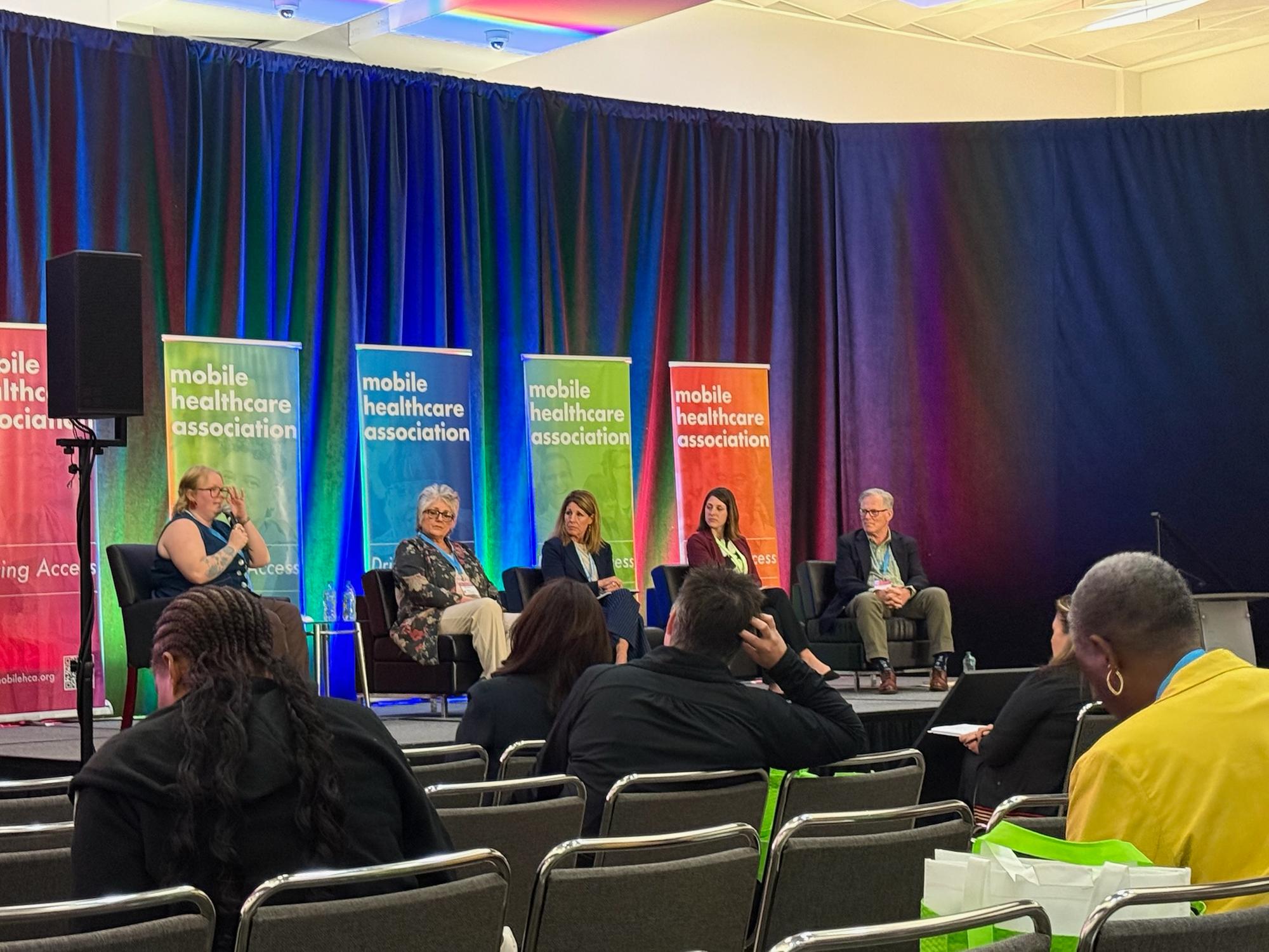 Five panelists onstage at the 2026 Mobile Healthcare Association conference
