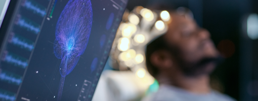 Monitors Show EEG Reading and Graphical Brain Model. In the Background Laboratory Man Wearing Brainwave Scanning Headset Sits in a Chair with Closed Eyes. In the Modern Brain Study Research Laboratory