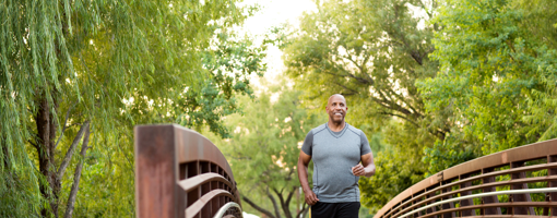 Mature African American man walking in the park.