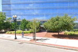 Screenshot (from Google Maps Street View) showing the exterior of the BMC/BUMC building located at 670 Albany Street (a large glass-faced high-rise lab building), from the entrance on Biosquare Drive.
