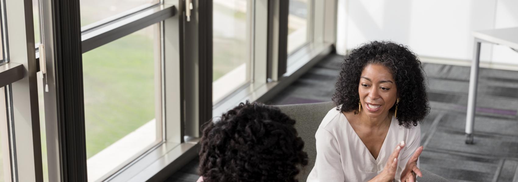 A high angle view of a mature adult therapist and mid adult patient working on issues.