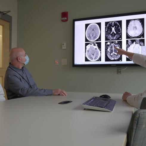 Boston Medical Center neurologists examine an x-ray image of the brain