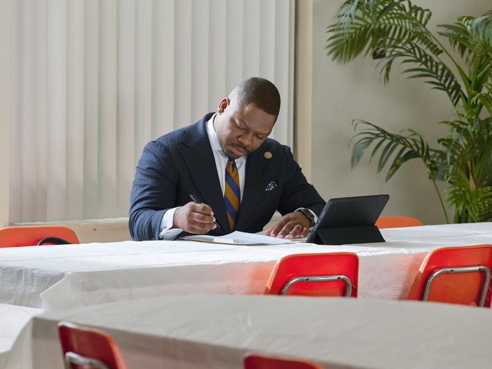 Reverend Bodrick working at a desk