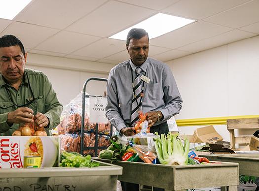 two men sorting produce